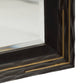 Close-up of a rectangular mirror with a dark wood frame and gold accents.