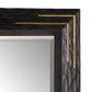 Mirror with a black frame featuring gold accents on a white background