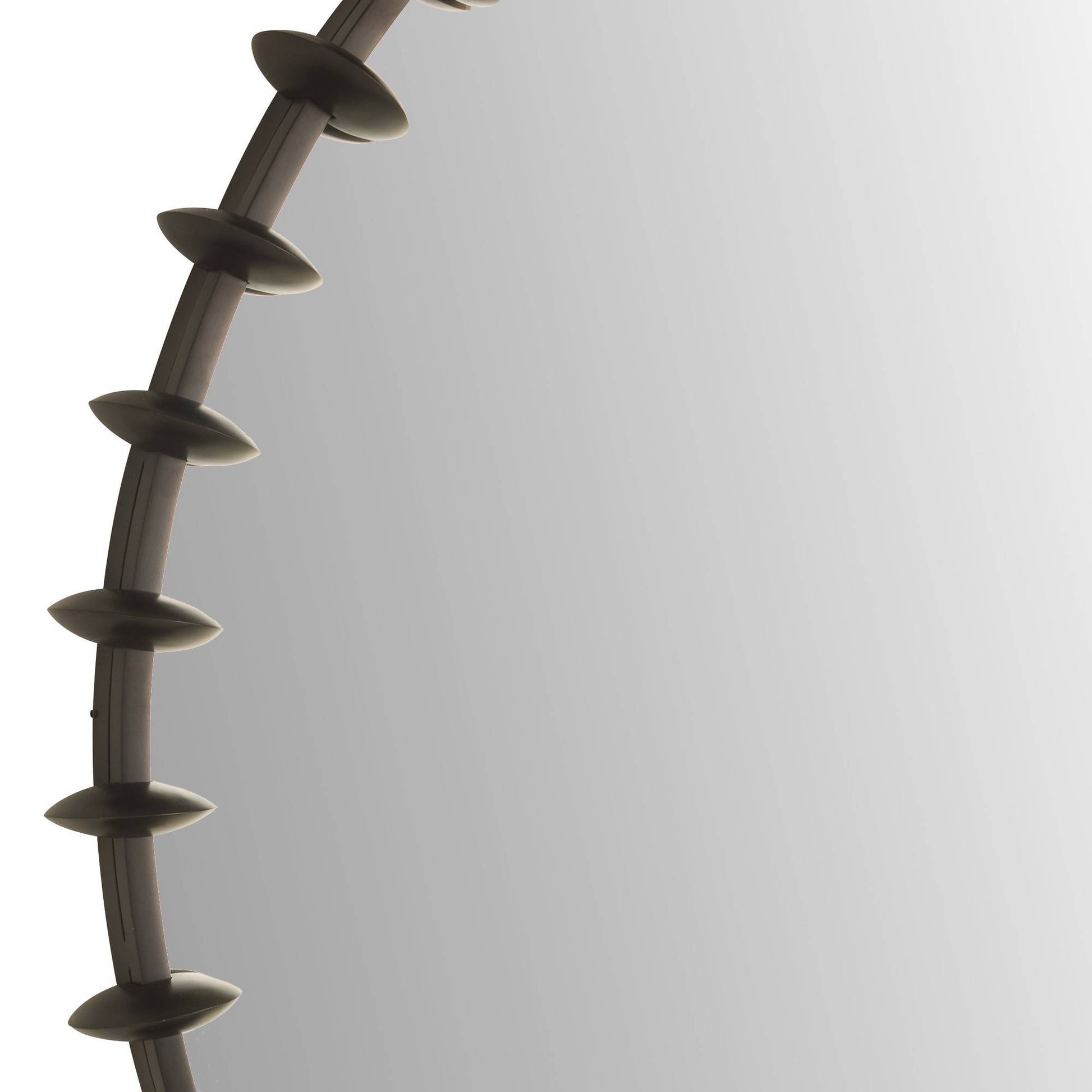 Round mirror with decorative frame on a white background