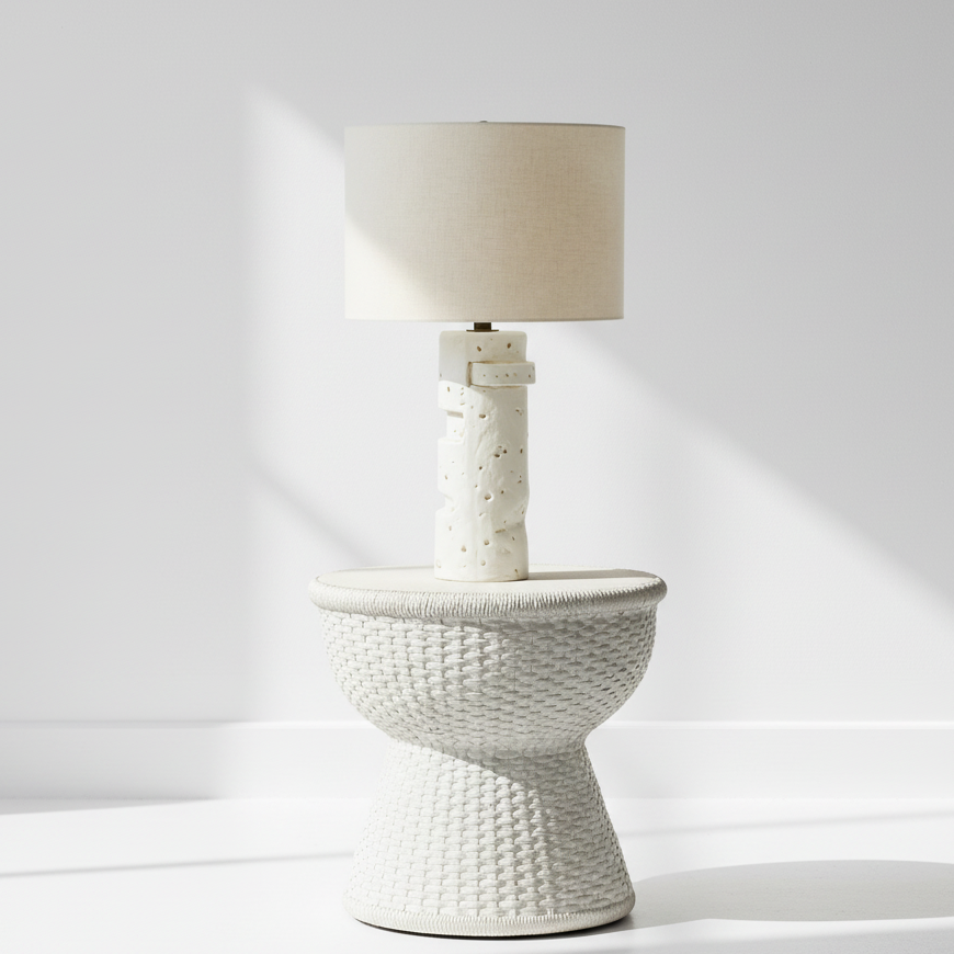 White textured table lamp with a beige lampshade on a white background
