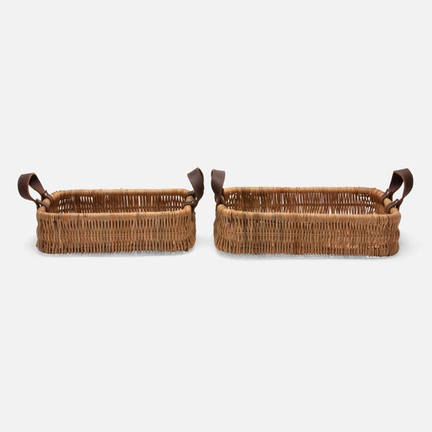 Two wicker baskets with handles on a white background