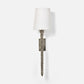 Wall sconce with textured metal base and white shade on a light gray background