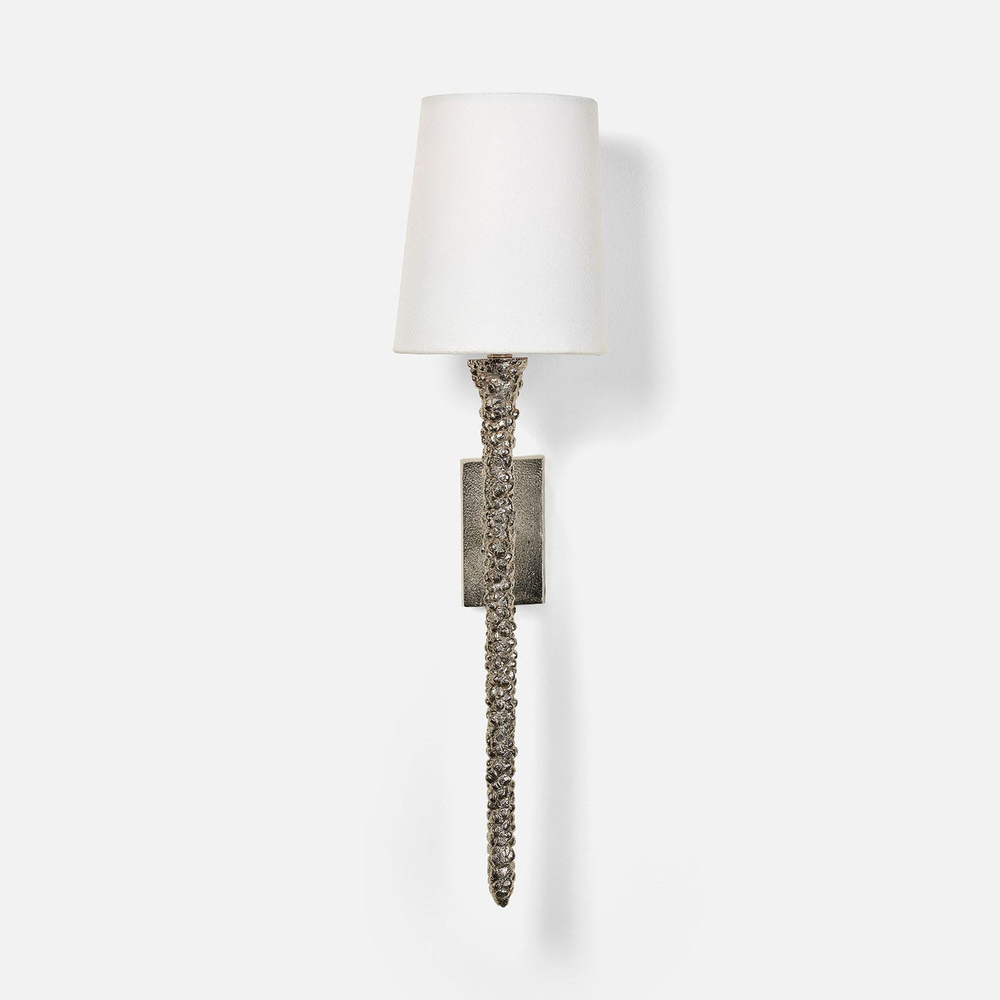Wall sconce with textured metal base and white shade on a light gray background