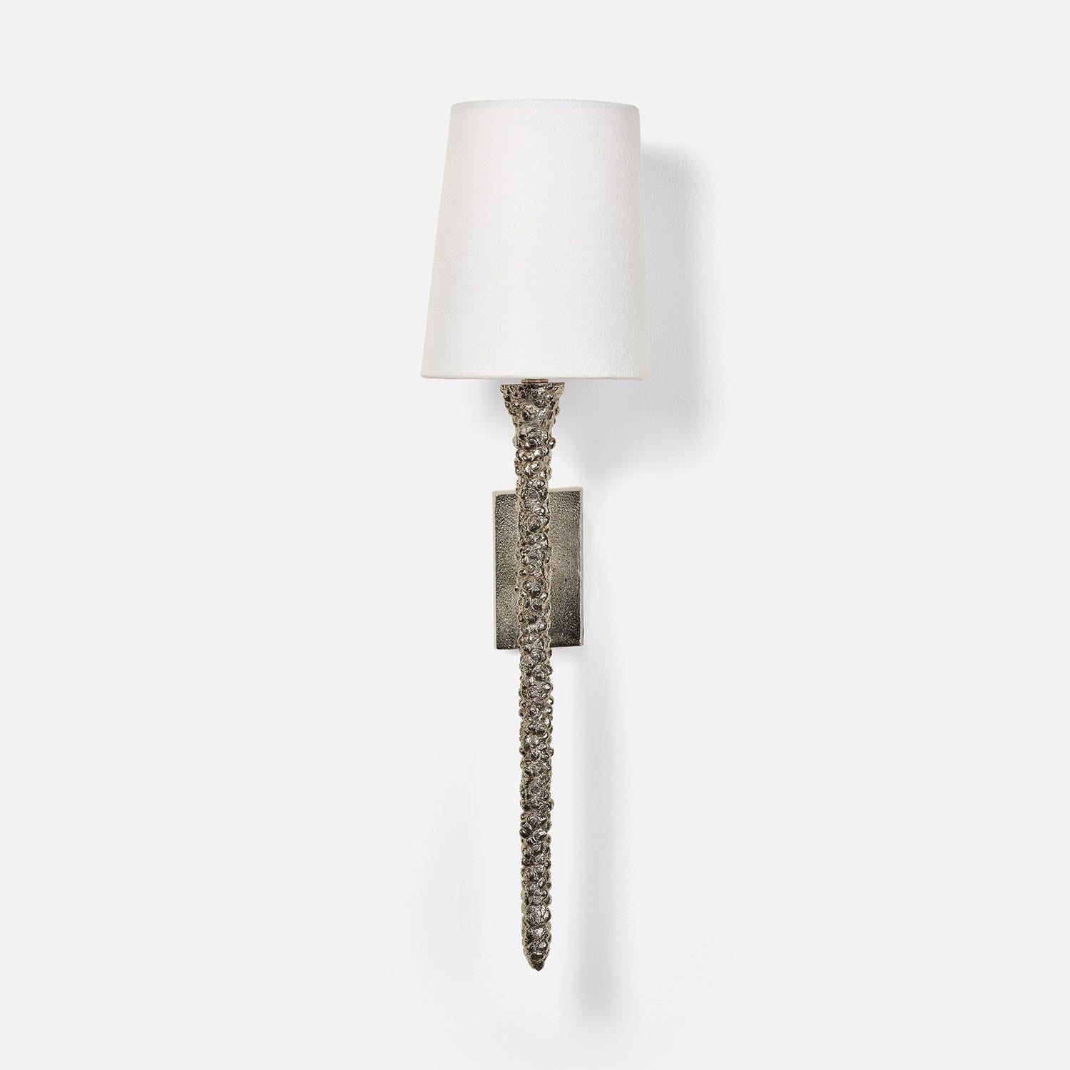 Wall sconce with textured metal base and white shade on a light gray background