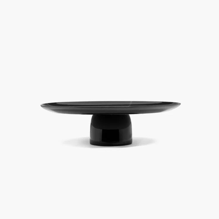 Black pedestal plate on a white background