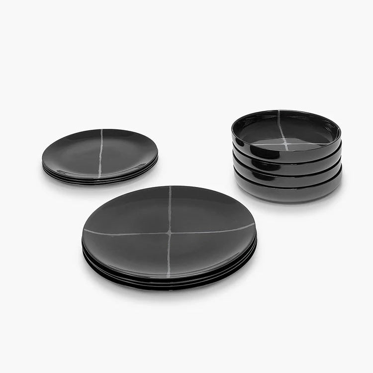 Set of black ceramic plates and bowls on a white background