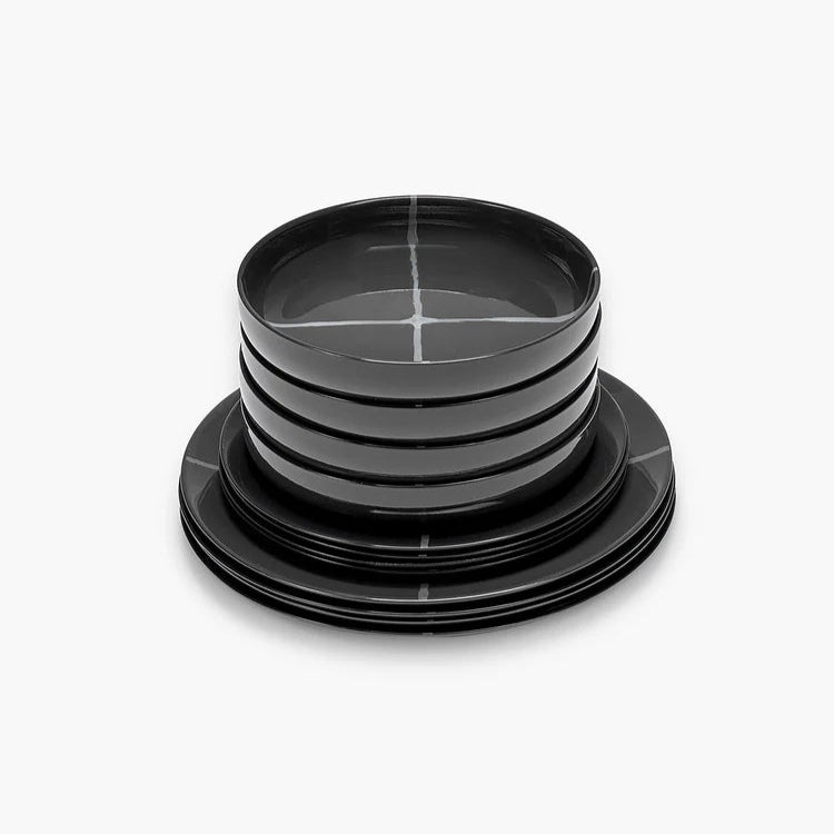Set of black ceramic plates with a geometric pattern on a white background