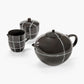 Black ceramic tea set with white lines on a white background