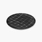 Round black plate with a grid pattern on a white background