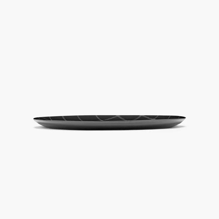 Black ceramic plate with geometric pattern on a white background