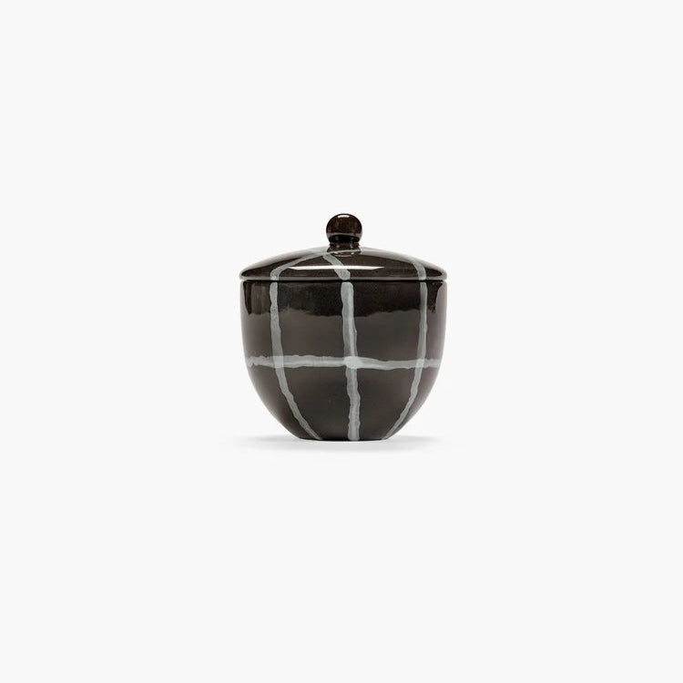Black and white checkered ceramic jar on a white background