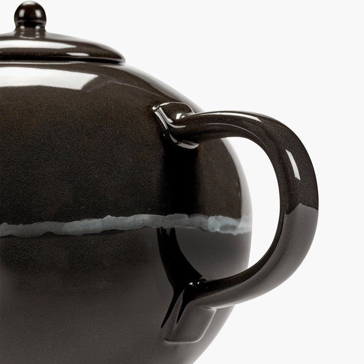 Black teapot with a white stripe on a white background