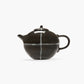 Black ceramic teapot with white stripe on a white background