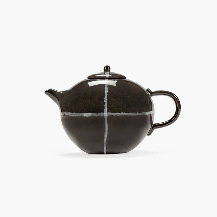 Black ceramic teapot with white stripe on a white background