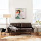 four hands modern cowhide rug natural brown styled in room