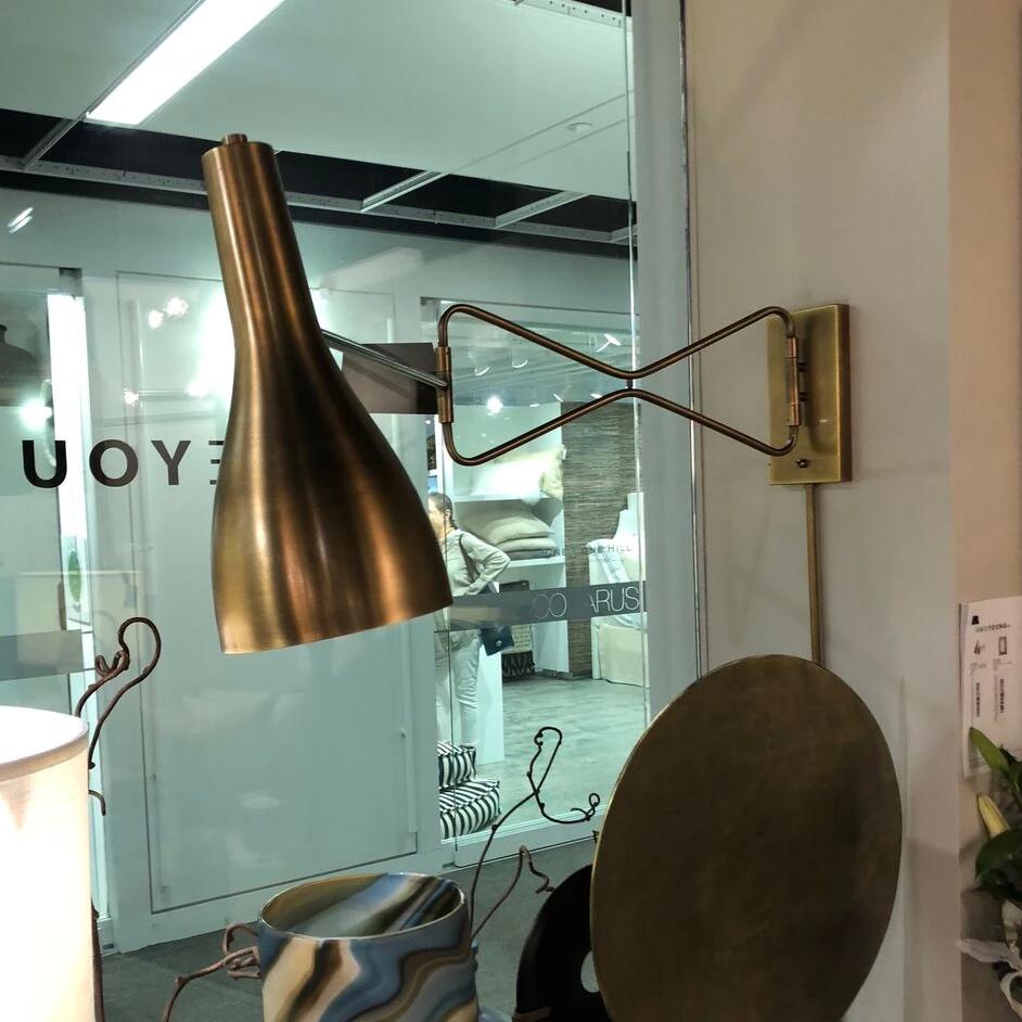 jamie young lenz wall sconce brass shown in room