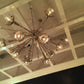 jonathan adler sputnik flush mount chandelier brass room view